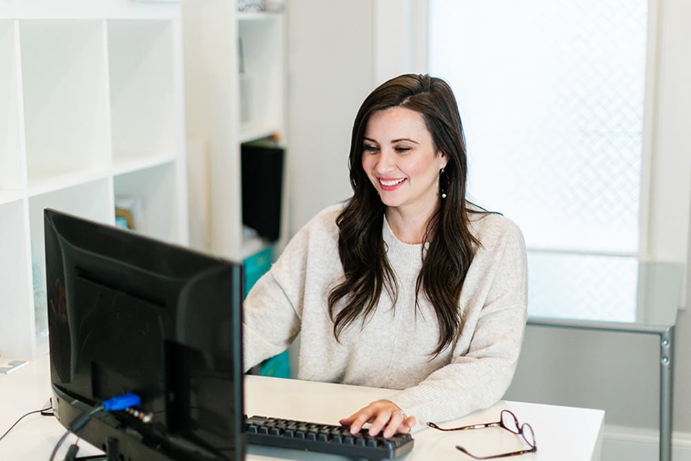 woman in office on desktop computer